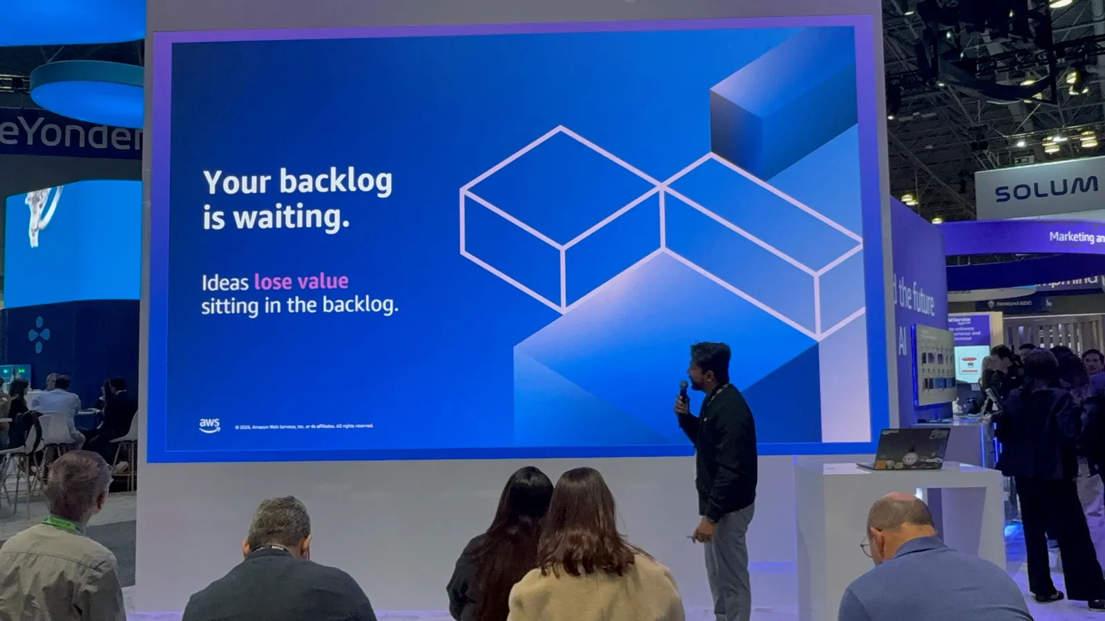 A slide reading Your backlog is waiting, with Ganesh Raam speaking